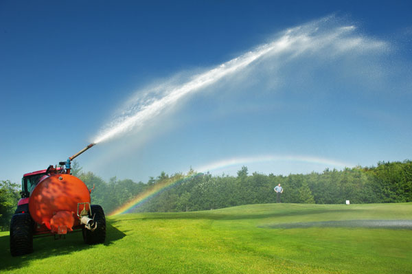 Michael Barry of Inagh, assistant greens keeper at Woodstock Golf Club, watches as his tanker sprays water on the 13th green as temperatures continue to soar. Photograph by John Kelly