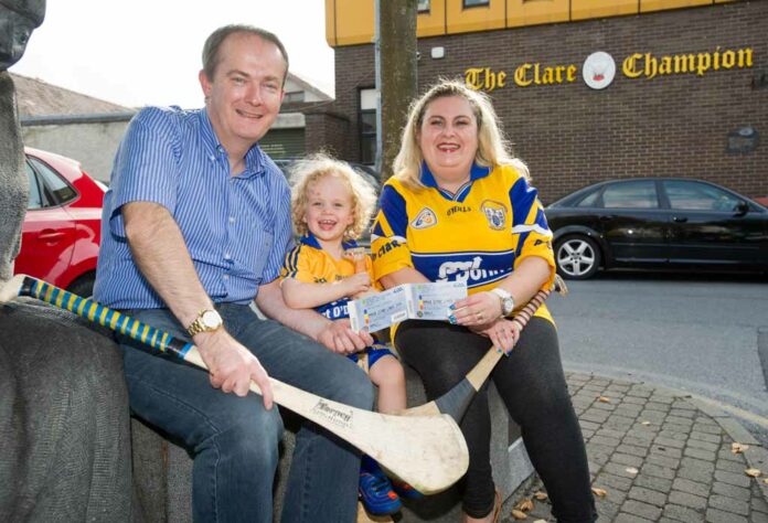 John Galvin, general manager the Clare Champion presents Louise Dunworth of Tulla and her son Harry (2) with a pair of tickets fro the All-Ireland hurling final replay in Croke park, first prize in the recent Clare Champion facebook competition. Photograph by John Kelly.