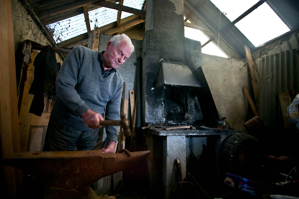 Blacksmith Tom Whelan in his forge in O'Dea's Road, Kilrush. Photograph by Arthur Ellis