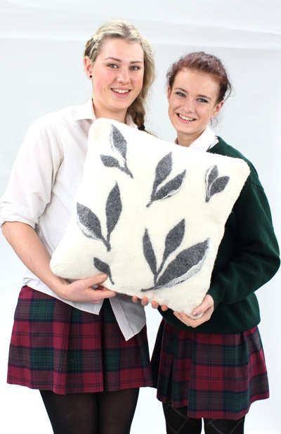 Ciara O'Connell and Rachel Sulley with a handmade, felted cushion designed by Ciara during the Creative Engagement project in Scoil Mhuire, Ennistymon.