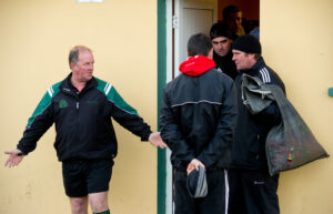 Referee Michael Talty meets with Doonbeg manager Ciaran O Neill and his men outside the dressing rooms at Kilmihil to discuss the county football quarter final. Photograph by John Kelly.