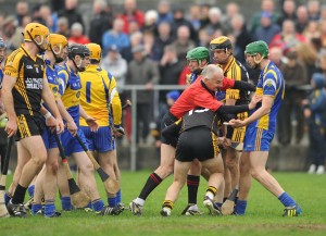 Referee Ambrose Heagney gets stuck in between sparring Newmarket and Ballyea players during the the closing stages of their semi-final at Clarecastle. Photograph by John Kelly.