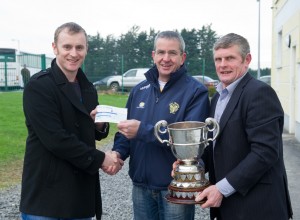 Chairman of Newmarket GAA Pat Keogh, centre, is presented with a cheque to the value of €3500  by Owen Ryan, of The Clare Champion watched by Joe Cooney, vice chairman Clare GAA, following their Clare Champion Cup final win at Clarecastle. Meanwhile, the Inagh-Kilnamona club recieved a cheque to the value of  €1500. Photograph by John Kelly.