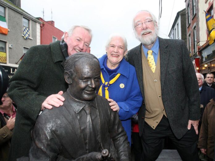 L-R Piper Liam O'Flynn with Judith and Barry Merrill at the unveiling of a statue of Willie Clancy in Miltown Malbay on Saturday.Pic Arthur Ellis.