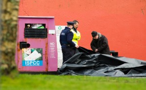 Priest, Fr Tom O Dea, at right with Gardai at the scene at Ballynacally where the body of a man in his sixties was discovered on Saturday morning. Photograph by John Kelly.