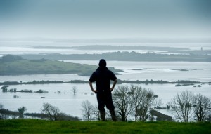 Paul O'Sullivan of Cooga, Kildysart, looking out over farms which which were covered by  flood water from the Shannon Estuary a few weeks ago. Photograph by John Kelly