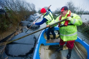 Floating Harvest.....Gerry Murtagh and his son Damien  move to salvage some of their silage bales after over 20 acres of their farm got flooded at Lacknashannagh, Kildysart on the Shannon Estuary. Photograph by John Kelly.