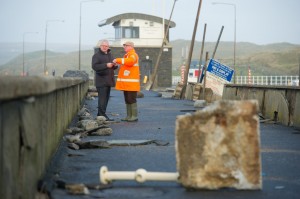 County manager Tom Coughlan and local businessman Odran O Looney view of some of the storm damage at Lahinch promenade. Photograph by John Kelly.