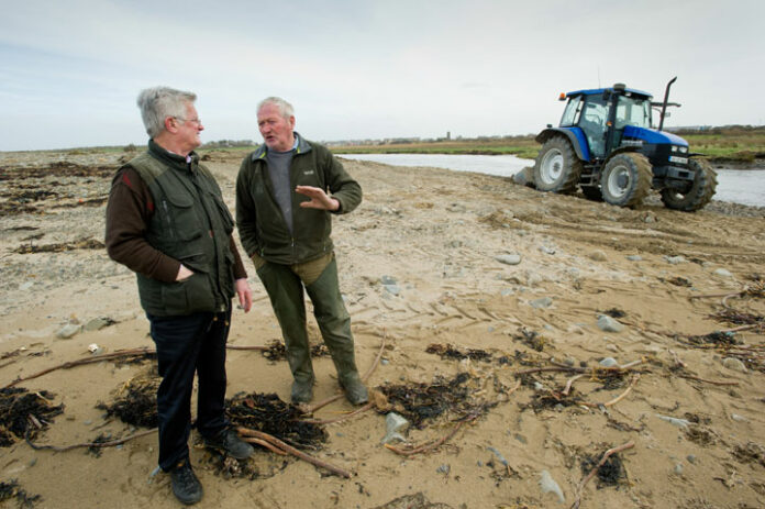 Tommy Comerford of the local Coastal Erosion Group with local farmer Paddy Doyle, whose land at Rhynagonnaught is damaged following the recent storms.