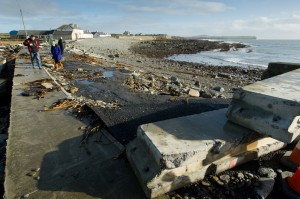 The main road in Kilbaha village covered by rocks, undermined in places and cut off following the latest high seas and gales at Kilbaha. Photograph by John Kelly.