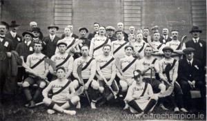 Players only, from left: Extreme back row wearing dark jerseys are John Rodgers; Patrick McDermott and Patrick Moloney. Standing l/r: Tom McGrath; John Fox; Rob Doherty; Michael Flanagan; Jim Clancy; Joe Power. Seated: Jim Guerin; Patrick ‘Fowler’ McInerney; Willie ‘Dodger’ Considine; Amby Power; Martin Moloney; Ned Grace; John Shalloo. Front seated: Brendan Considine; James ‘Sham’ Spellissy. Also in the photograph are Dr. T.P. Fitzgerald (team doctor); James O’Regan (chairman of Clare County Council); Jim O’Hehir (team trainer) and Stephen Clune (chairman of the Clare County Board).