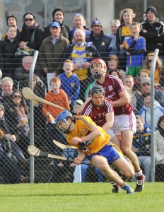 Shane O Donnell of Clare goes down under pressure from Galway's Ronan Burke and Fergal Moore during their NHL Division 1 Round 5 game at Cusack park, Ennis. Photograph by John Kelly.