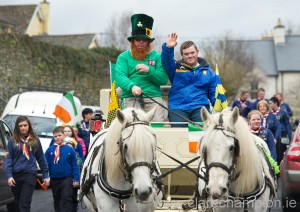 John O Grady,  flanked by Sixmilebridge sporting stalwart, Ronan Keane, leads the parade with his horses and carriage at Sixmilebridge. Photograph by John Kelly.