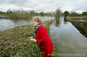 Hilary Gough surveying the flooding near her home at Ballycar