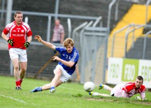 Cratloe's Podge Collins slots the ball past Eire Og's goalie Colin Smith during their Senior Football game at Cusack park Ennis on Saturday evening. Pic Arthur Ellis.