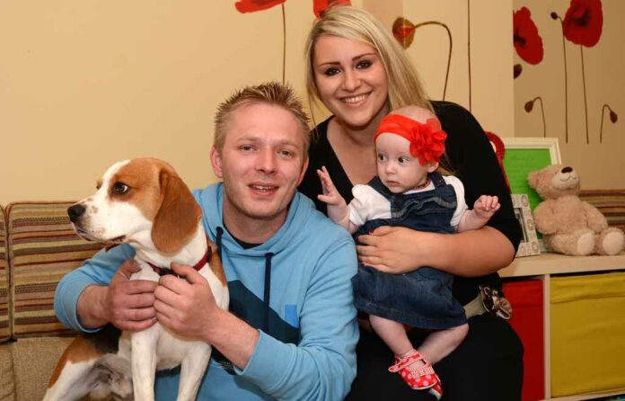 Daniel Drzewiecki and Julija Kolpakova at home with their baby daughter, Laura Olivia, and dog, Charlie.