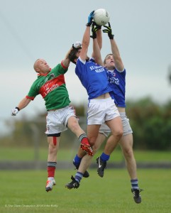 Michael Hogan of Kilmurry Ibrickane in action against Conor Murray and Darren Owens of Kilkee during their senior championship game in Doonbeg. Photograph by John Kelly.