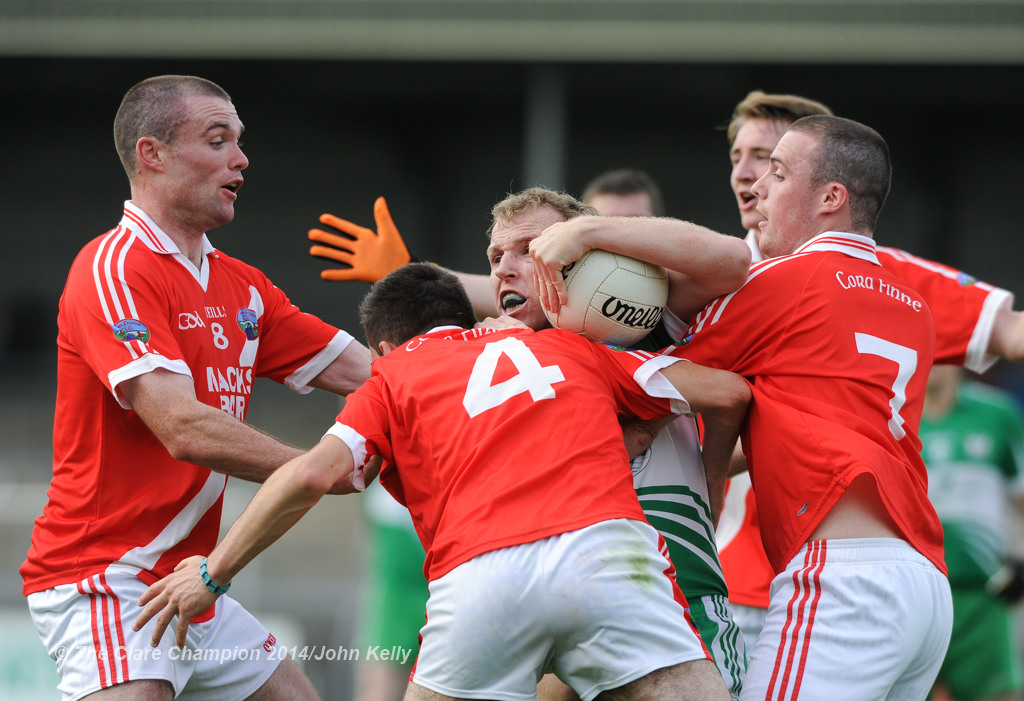 Wolfe Tones Ian Collins is well tackled by Corofin's John Keane, Shay Malone and Colm Rice during their Intermediate final at Cusack park. Photograph by John Kelly.