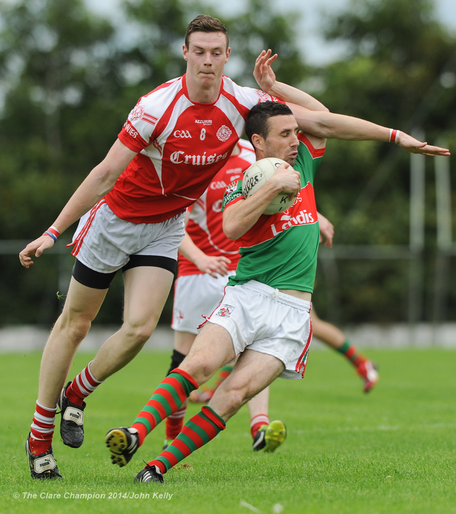 Darren O Neill of Eire Og in action against Shane Hickey of Kilmurry Ibrickane during their senior championship semi-final at Kilmihil. Photograph by John Kelly.