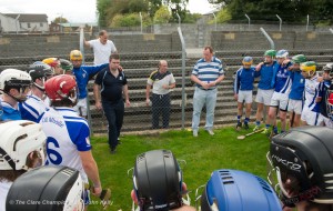 Kilmaley manager Niall Romer gives the team talk to his charges fro outside the wire before their Minor A county final at Cusack Park Photograph by John Kelly.