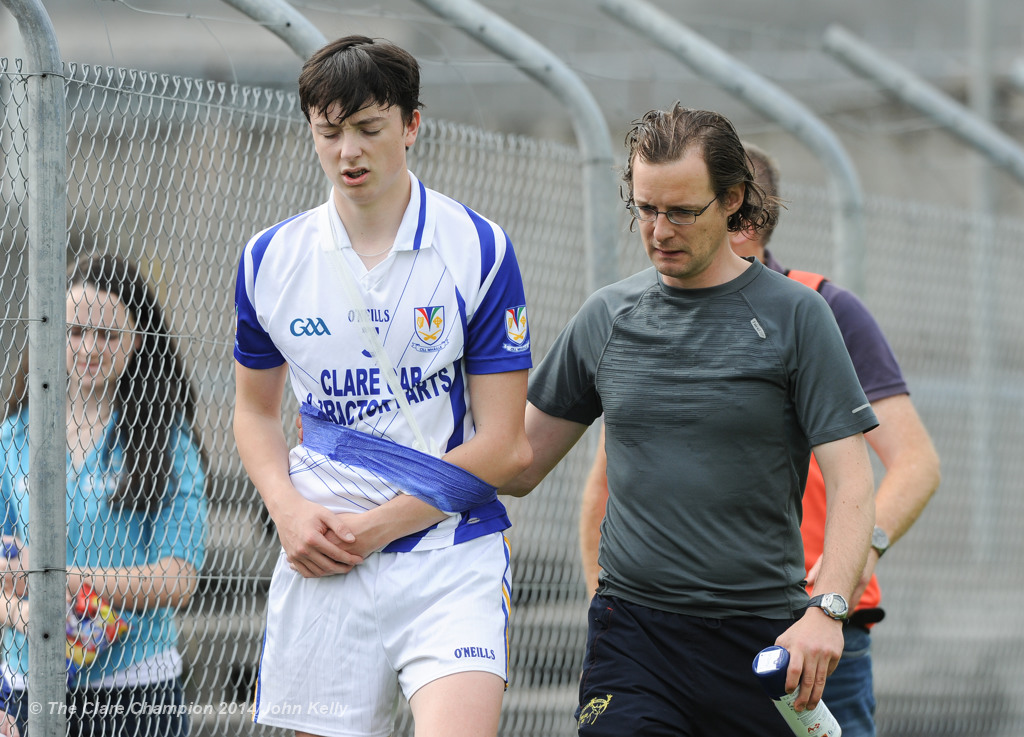 Colin Hehir of Kilmaley is escorted off with an injury by physio Keir Mc Namara during their Minor A county final at Cusack Park Photograph by John Kelly.