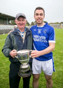  Cratloe manager Joe McGrath with his son Conor after victory over Crusheen in the County Final.Pic Arthur Ellis.