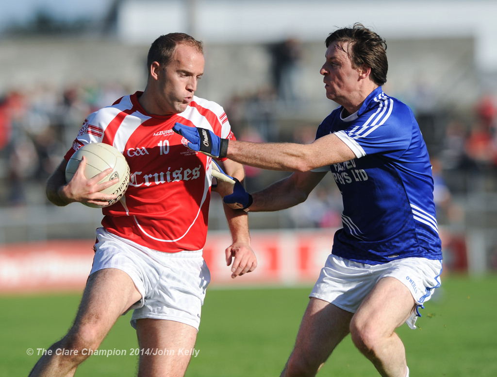 Stephen Hickey of Eire Og in action against Barry Duggan of Cratloe during their senior football final at Cusack park. Photograph by John Kelly.