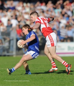 Podge Collins of Cratloe in action against Conor Brennan of Eire Og during their senior football final at Cusack park. Photograph by John Kelly.