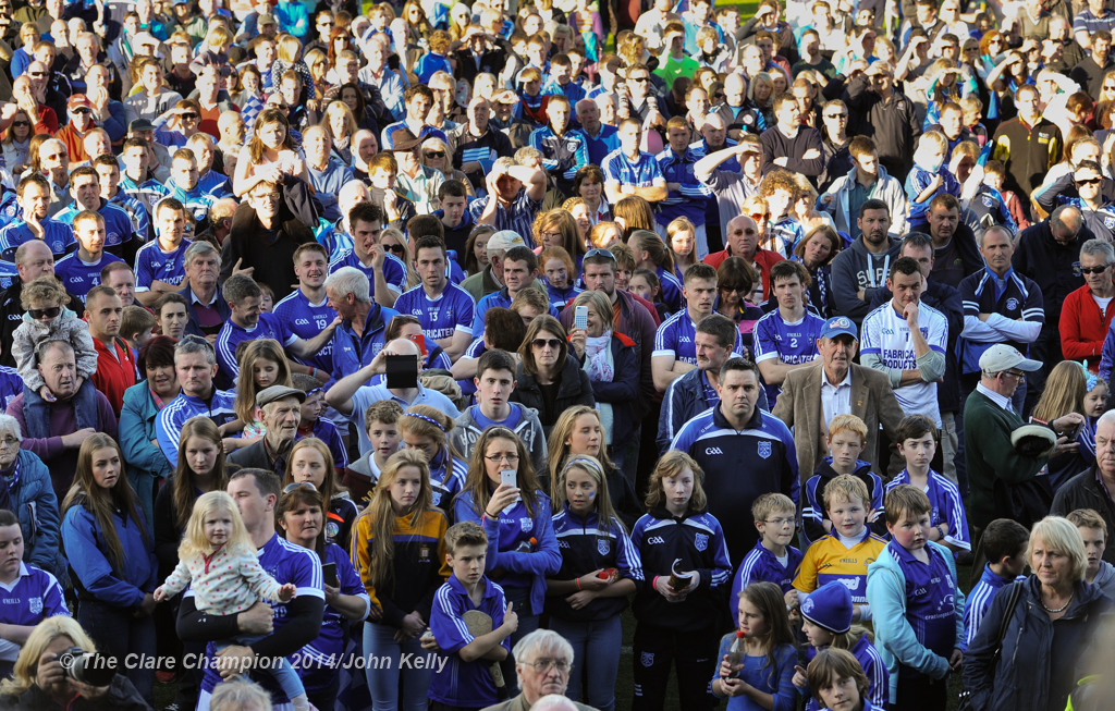 The Cratloe crowd look on as captain Micheal Hawes of  lifts the cup following their senior football final win over Eire Og at Cusack park. Photograph by John Kelly.