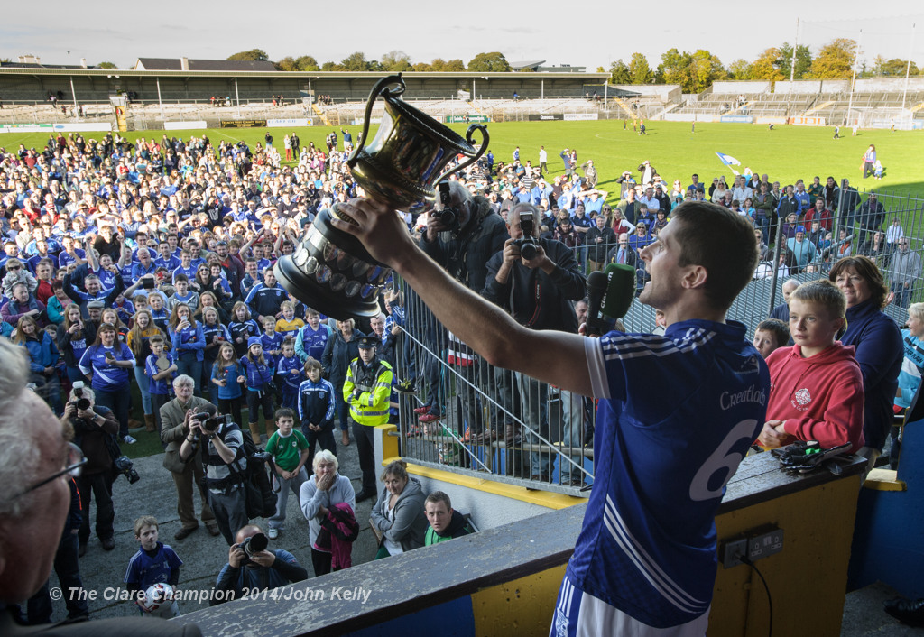 The Cratloe crowd look on as captain Micheal Hawes of  lifts the cup following their senior football final win over Eire Og at Cusack park. Photograph by John Kelly.