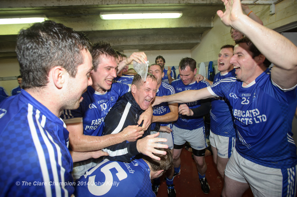 The Cratloe lads celebrate with manager Colm Collins  in the dressing room following their senior football final win over Eire Og at Cusack park. Photograph by John Kelly.