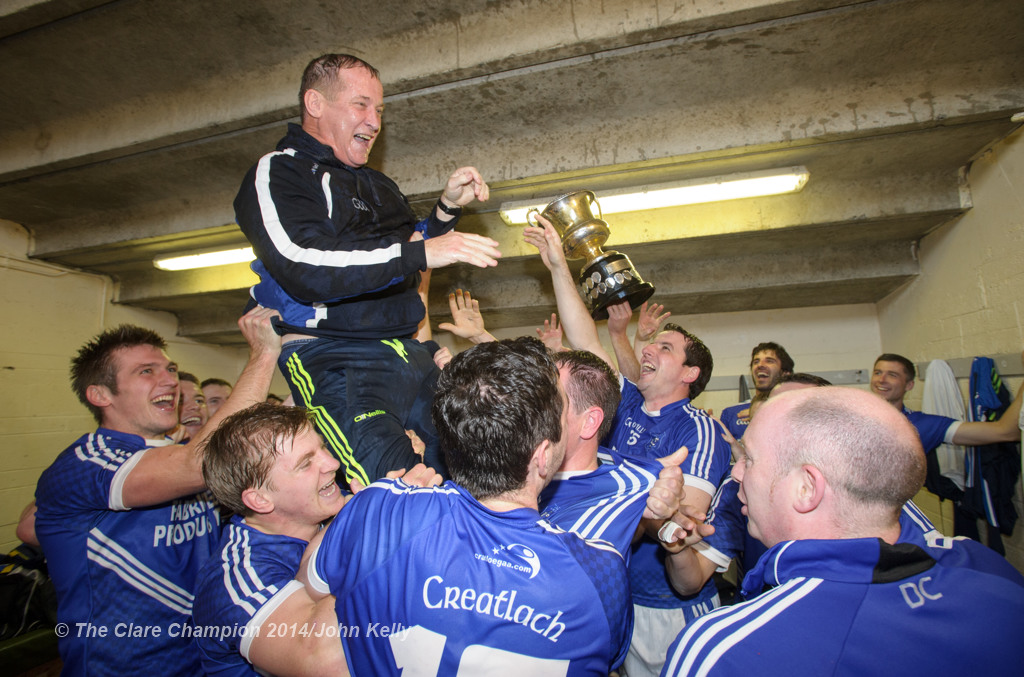 The Cratloe lads celebrate with manager Colm Collins  in the dressing room following their senior football final win over Eire Og at Cusack park. Photograph by John Kelly.