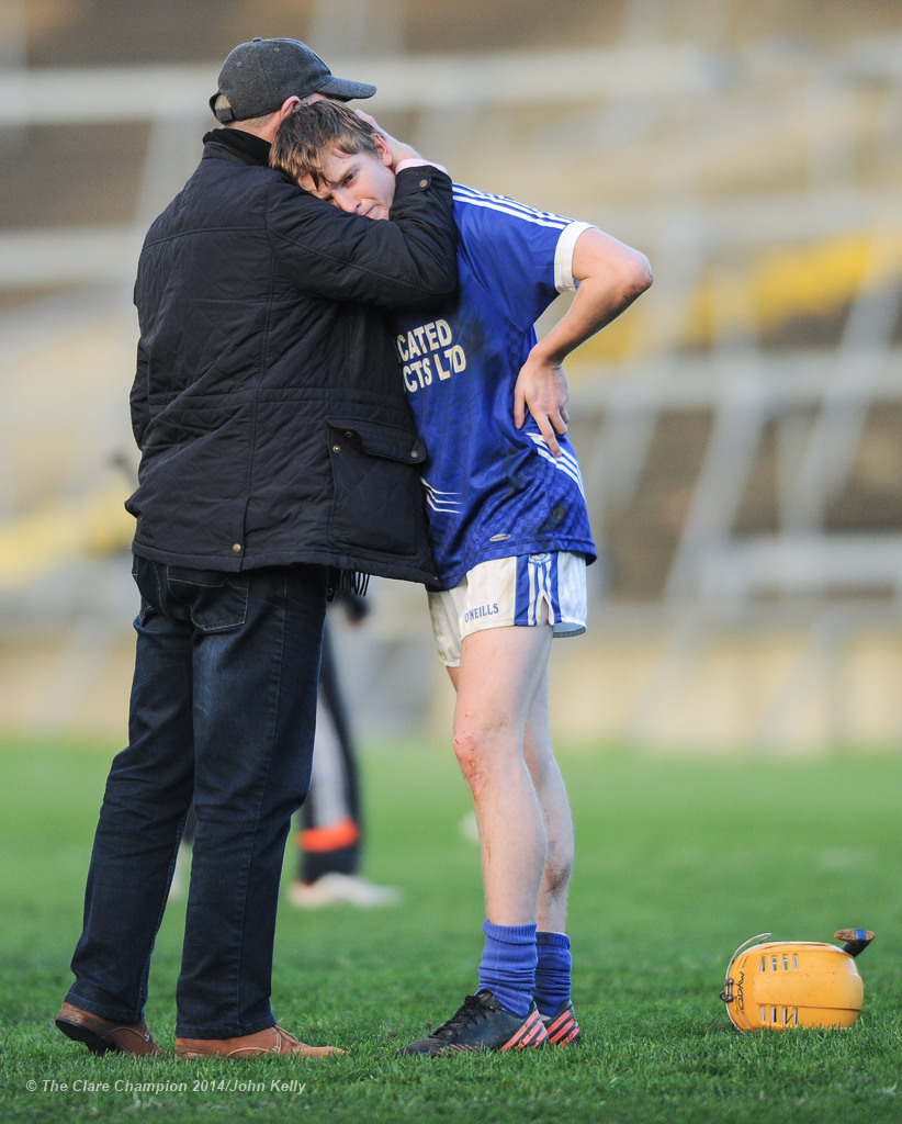 A disappointed David Collins of Cratloe is comforted by a supporter following the loss to Kilmallock in the Munster Club final at The Gaelic Grounds. Photograph by John Kelly.