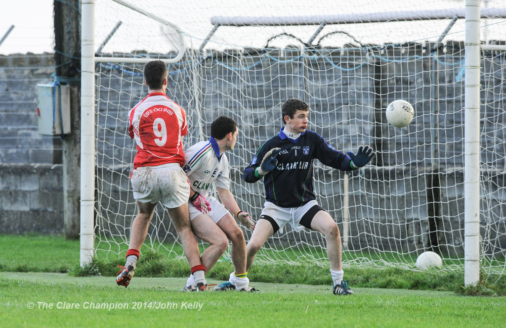 Dara Walsh of Eire Og scores a goal against David Mc Namara and John Fawl of Clann Lir during the  U-21A final in Miltown Malbay. Photograph by John Kelly.