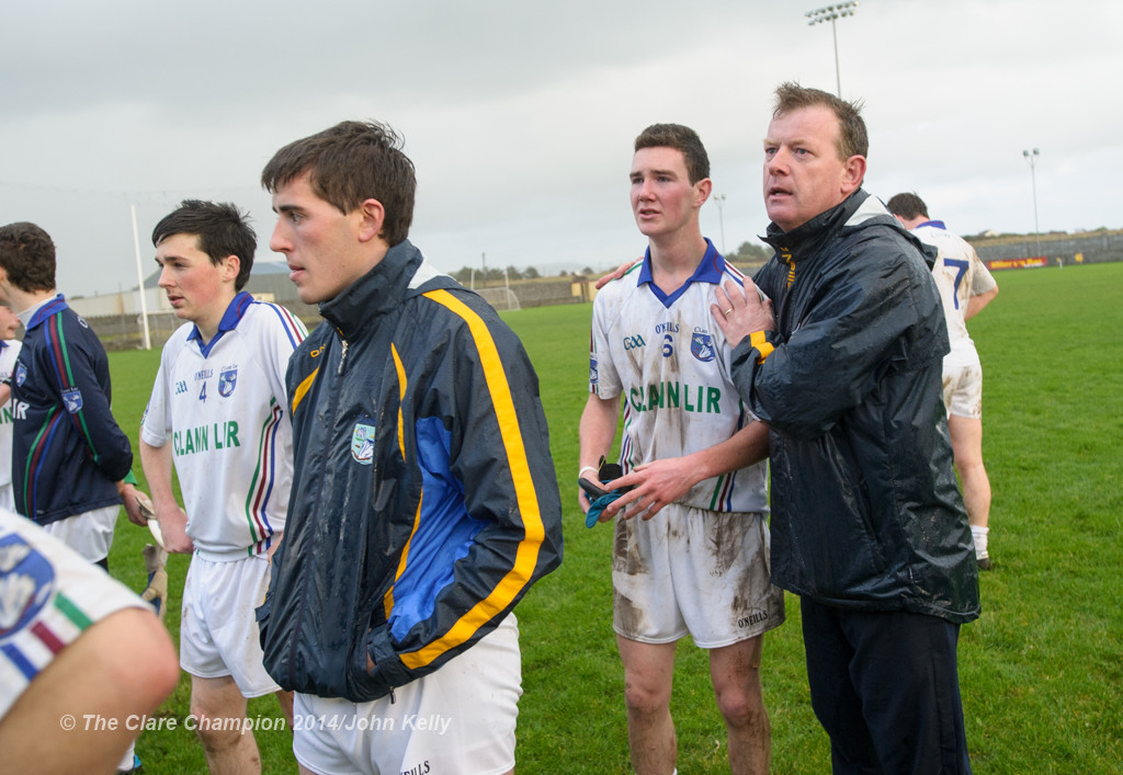 A clearly disappointed Darren Nagle of Clann Lir is comforted by Eire Og management member Donal O hAinifein following the  U-21A final in Miltown Malbay. Photograph by John Kelly.