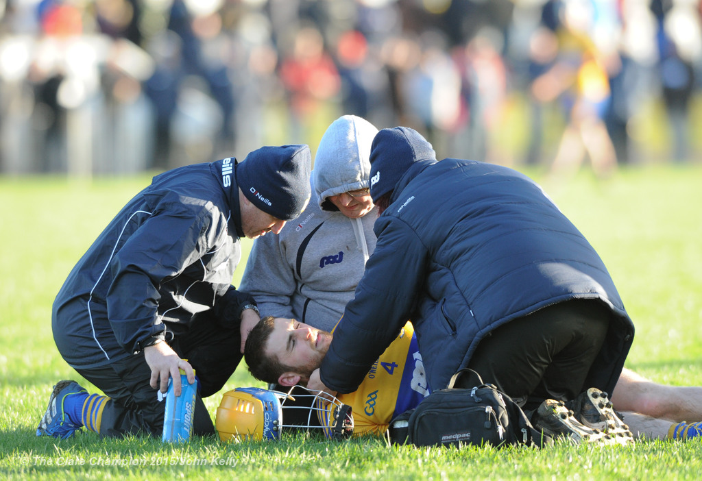 Seadna Morey of Clare is treated for an injury during their Waterford Crystal Cup game at Sixmilebridge. Photograph by John Kelly.