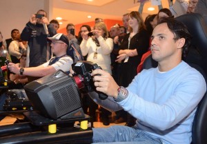 Felipe Massa takes on a Genworth employee in a race on an F1 simulator. Photo John Galvin.