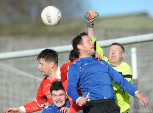 Goalie Trevor O Donnell and Paddy Purcell of Newmarket Celtic defend the goals against Darragh Fitzgerald and Mark Culbert of Bridge United during their top of the table Premier League clash at Newmarket. Photograph by John Kelly.