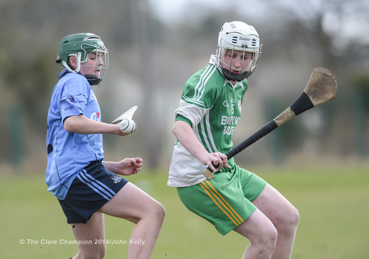 Patrick Ryan of Scariff Community College  in action against Jason Devereux of Ennistymon CBS during their Munster U-15 D final at Clarecastle. Photograph by John Kelly.