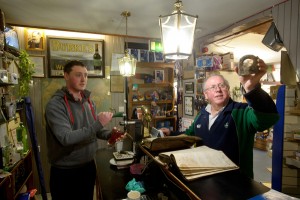 Publican/Hardware shop owner and wool merchant Colman Keane and his son Peter with some of their old ledgers and the hoop that WB Yeats used tie his horse to, in the family's premises at Gort.  Photograph by John Kelly.