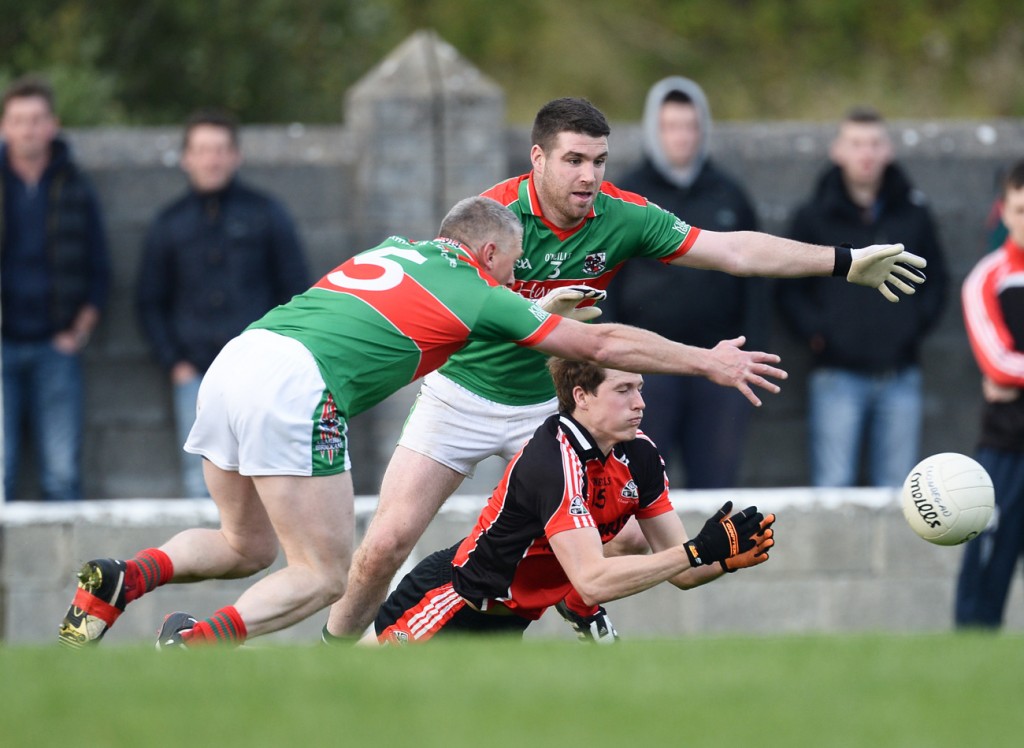 Brian Carrig of Clondegad in action against Thomas O Connor and Darren Hickey of Kilmurry Ibrickane during their Cusack Cup final in Kilmihil. 