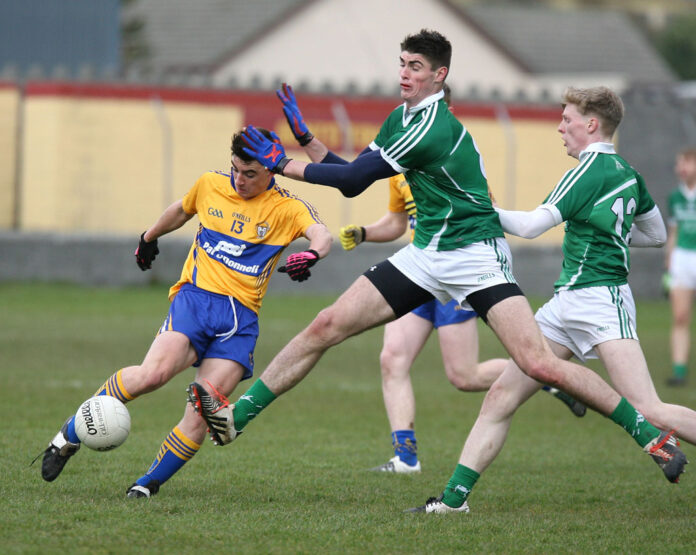 Clare's Sean Rouine under pressure from Limerick's Josh Ryan at Miltown on Wednesday night. Photograph by Arthur Ellis