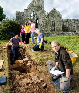 Archaeologist Graham Hull recording information uncovered on an archaeological dig in the shadow of Quin Abbey. In the background are volunteers Ritchie Jones, Ita Lawton, Fiona Clancy with her daughter Lilian, and Mary Howard. Photograph by John Kelly.