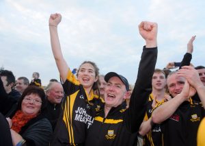 Robbie Hogan, Ballyea manager, and his daughter, Emma watch the cup presentation following the win over Clonlara in the county final replay at Cusack Park. Photograph by John Kelly.