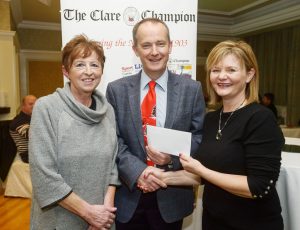 Clare Champion managing director John Galvin presenting Ann Gavin and Shirley Benson of the Cahercalla Hospice Charity Shop with first prize at the announcement of the winners of the annual Clare Champion Christmas Shop Window Display competition. Photograph by John Kelly.