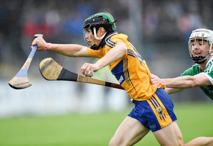 Gary Cooney of Clare in action against Conor Flahive of Limerick during their Munster Minor Hurling Championship semi-final at Cusack Park. Photograph by John Kelly.