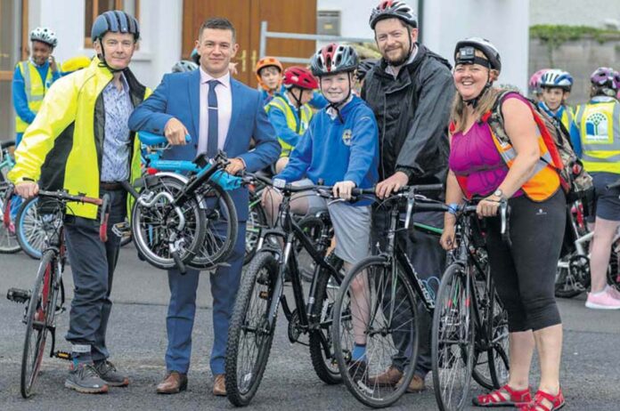 At the School Cycle at Ennis Fire Station on Wednesday were, from left, Clare Champion managing director John Galvin; Clare hurler and advertising sales representative of The Clare Champion, David Reidy, CBS pupil Mark Glynn and his dad, Darragh and organiser, Róisín Garvey.