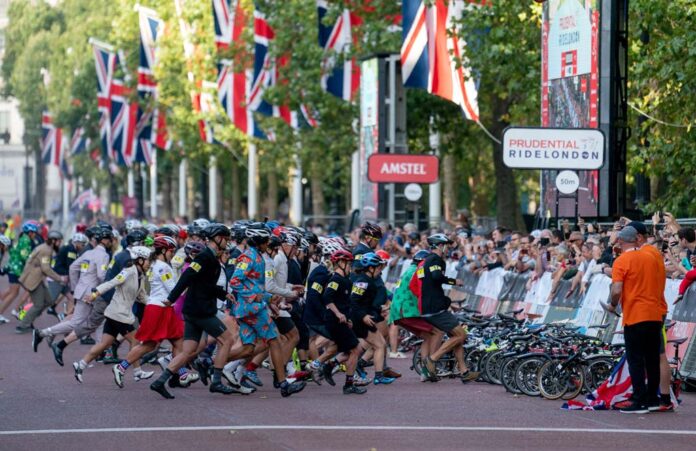 Competitors race towards their bikes at the start of the Brompton World Championships in London.