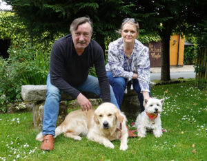 Evan Doyle, owner of BrookLodge and Shelly Galvin with Lewis and Daisy in the Orchard at BrookLodge.